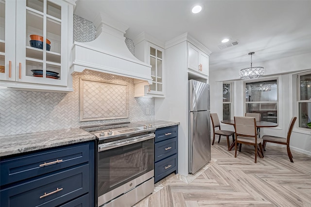 kitchen featuring blue cabinetry, appliances with stainless steel finishes, custom exhaust hood, and white cabinets