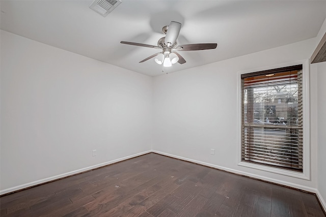 empty room with dark wood-type flooring and ceiling fan