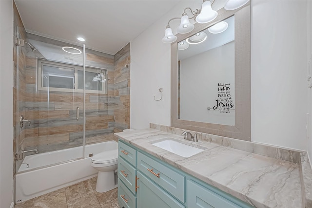 full bathroom featuring vanity, enclosed tub / shower combo, and toilet