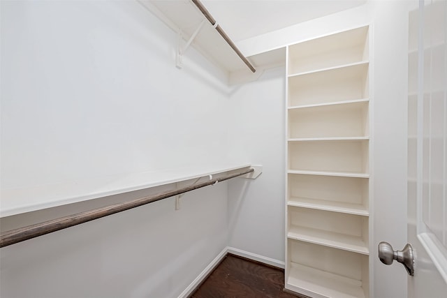 walk in closet featuring dark wood-type flooring