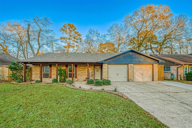 single story home with a garage and a front lawn