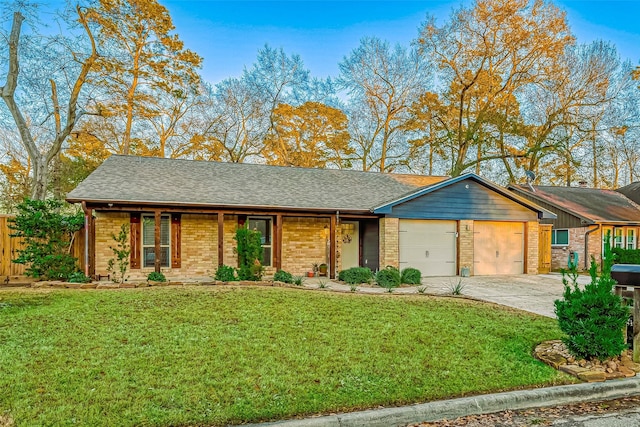 single story home featuring a garage and a front yard