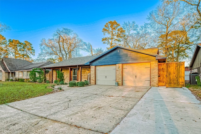 ranch-style house with a garage and a front lawn