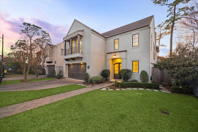 view of front of house with a garage and a yard