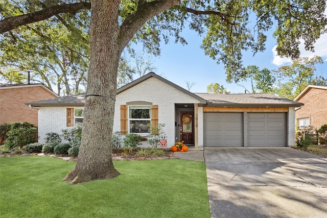 ranch-style home featuring a garage and a front lawn