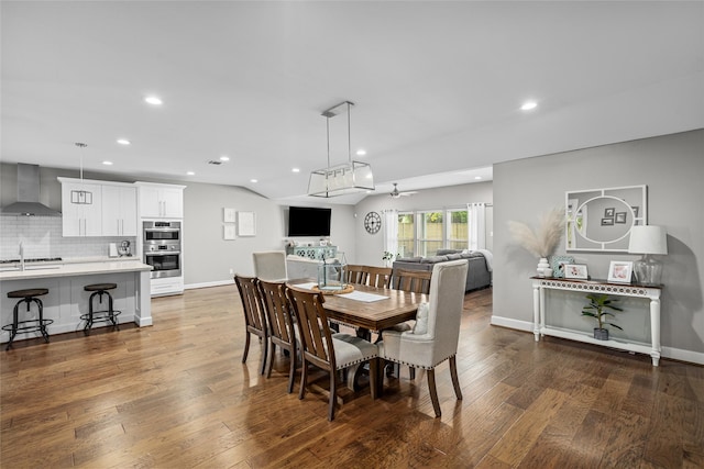 dining space with hardwood / wood-style flooring, ceiling fan, and sink