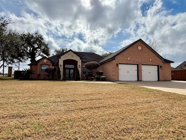 view of front of property featuring a garage and a front lawn