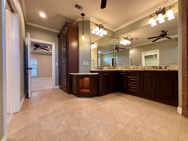 bathroom featuring ornamental molding, a ceiling fan, visible vents, and double vanity