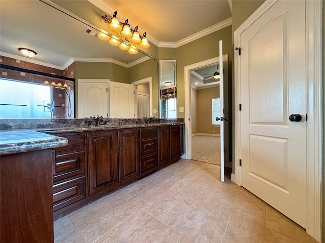 bathroom featuring vanity, crown molding, and a shower with door