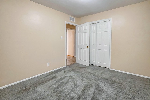 unfurnished bedroom featuring a closet and carpet