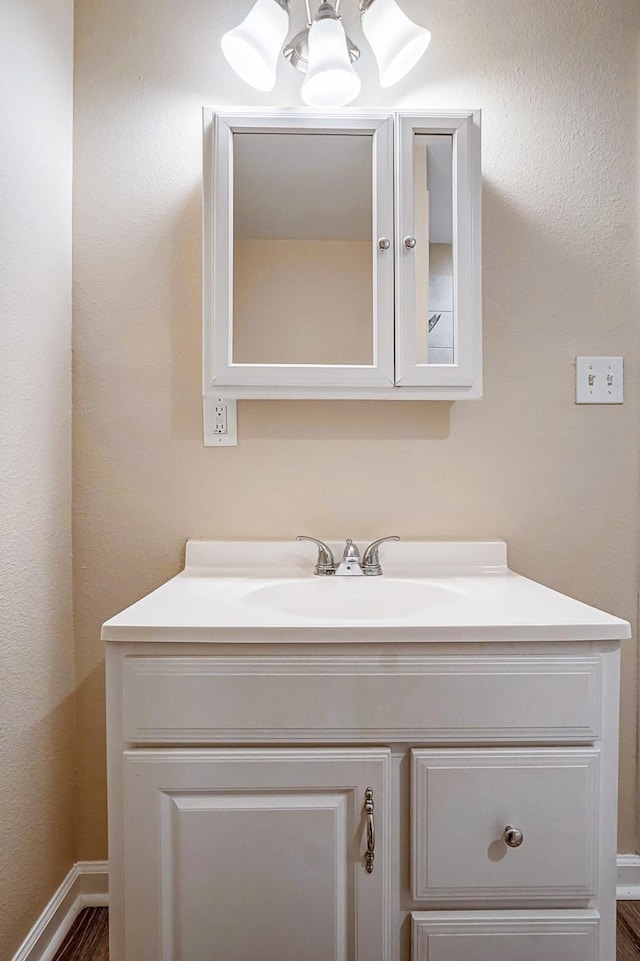 bathroom with vanity and a notable chandelier