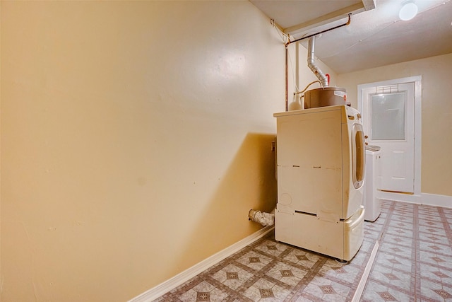 clothes washing area with washer / dryer