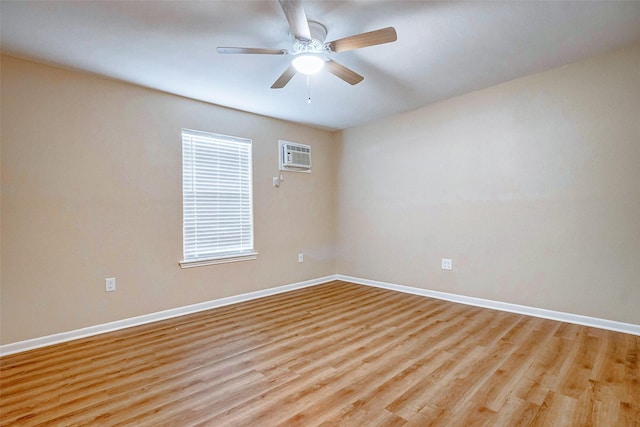 empty room with ceiling fan, a wall unit AC, and light hardwood / wood-style flooring