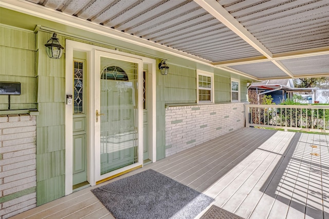 wooden terrace featuring covered porch