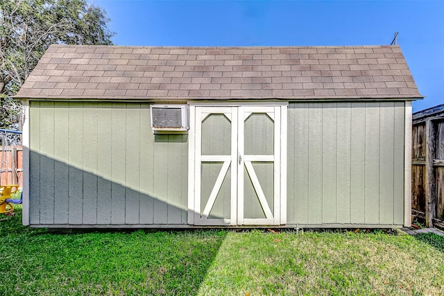 view of outbuilding featuring a lawn