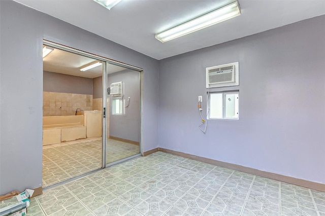 unfurnished room featuring a wall mounted air conditioner