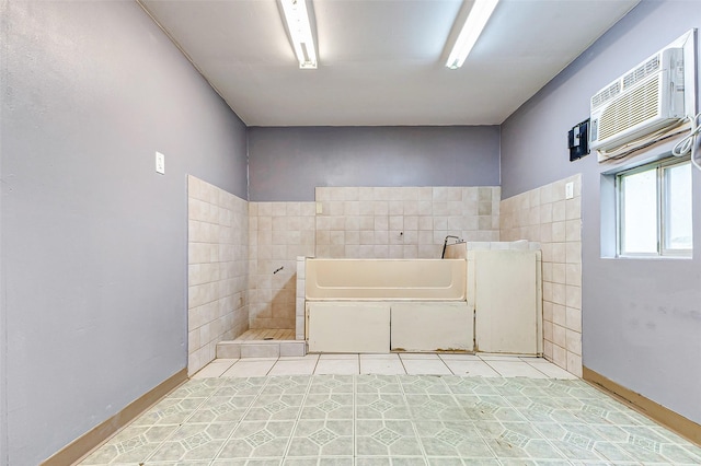 bathroom with a wall mounted air conditioner and tile walls