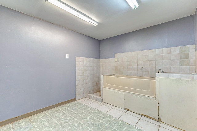 bathroom featuring tile patterned flooring and tile walls