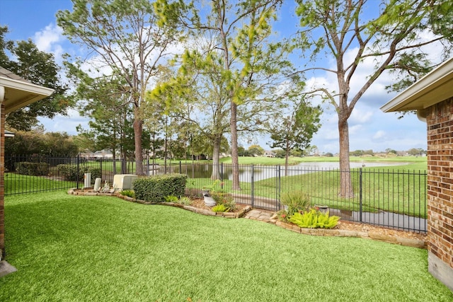 view of yard featuring a water view and fence