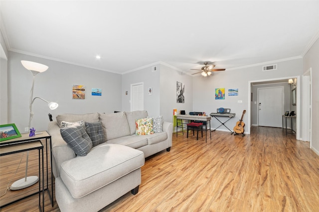 living room featuring ornamental molding, ceiling fan, and light hardwood / wood-style floors