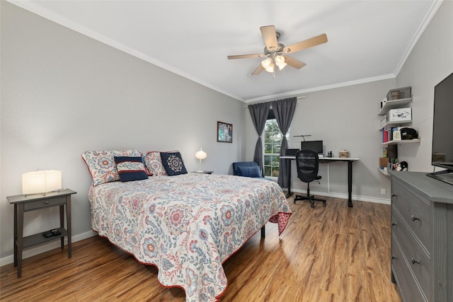 bedroom with crown molding, hardwood / wood-style flooring, and ceiling fan