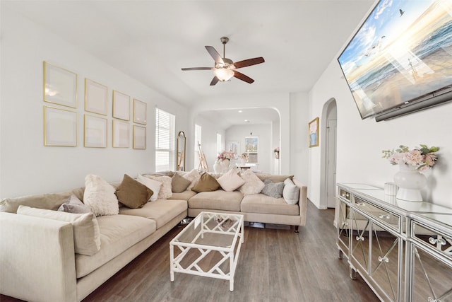 living room featuring dark wood-type flooring and ceiling fan