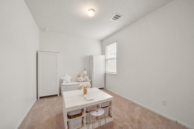 bedroom featuring light colored carpet