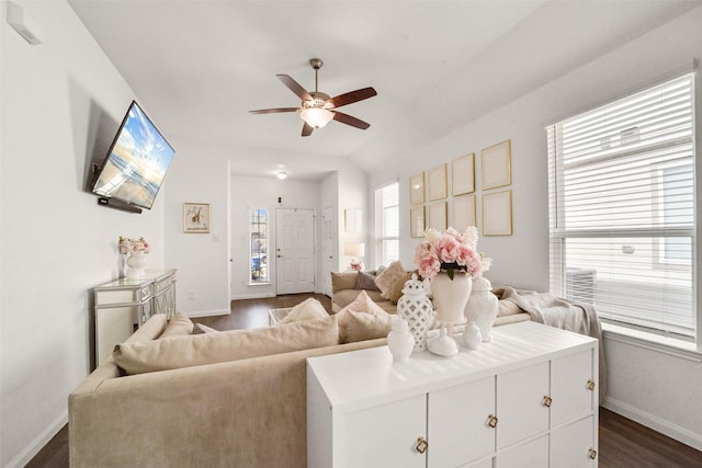 living room featuring ceiling fan, vaulted ceiling, and dark hardwood / wood-style flooring