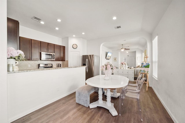 dining room with hardwood / wood-style floors and ceiling fan