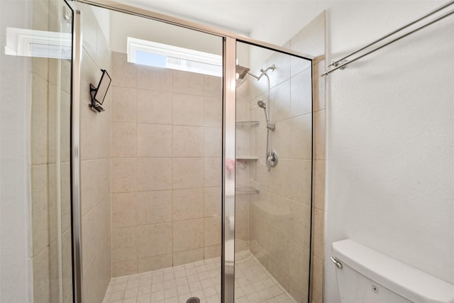 bathroom with an enclosed shower and toilet