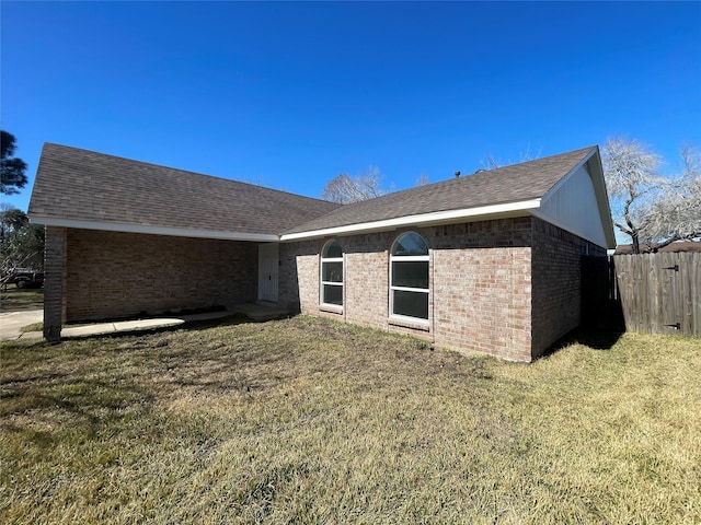 view of side of home with a lawn