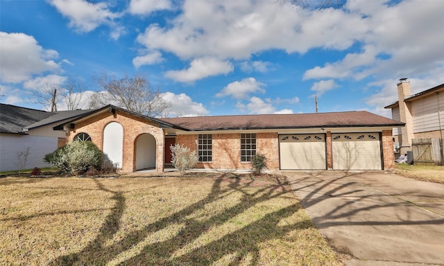 ranch-style house featuring a garage and a front yard