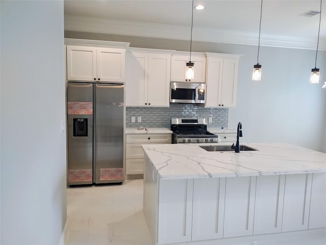 kitchen featuring appliances with stainless steel finishes, a sink, white cabinetry, and pendant lighting