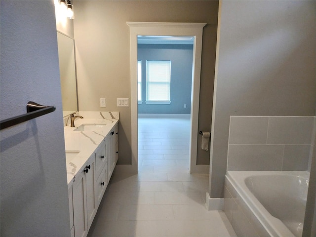 bathroom featuring vanity, tiled tub, and tile patterned floors