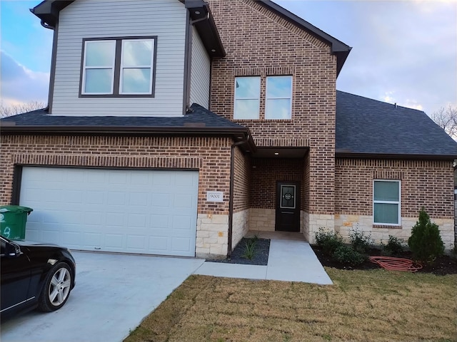 view of front of property with brick siding, a shingled roof, an attached garage, stone siding, and a front lawn