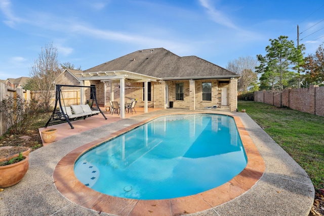 view of pool featuring a yard, a pergola, and a patio area