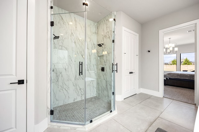 ensuite bathroom featuring ensuite bath, a marble finish shower, baseboards, and tile patterned floors