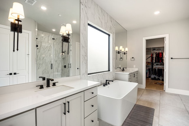 bathroom featuring two vanities, visible vents, a sink, a freestanding bath, and a marble finish shower