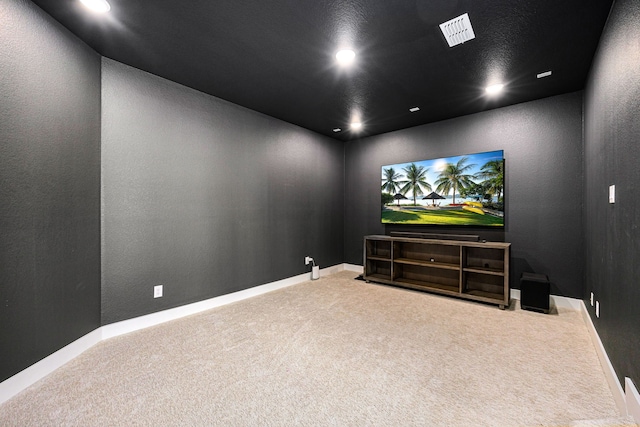 carpeted cinema featuring baseboards, a textured wall, visible vents, and recessed lighting