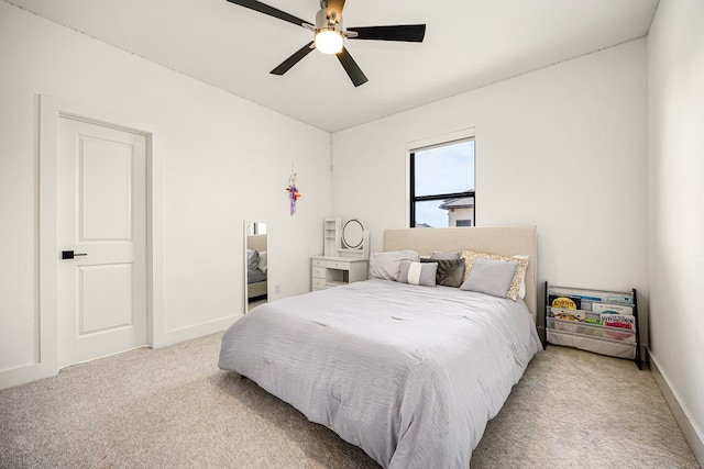 bedroom featuring light carpet, ceiling fan, and baseboards