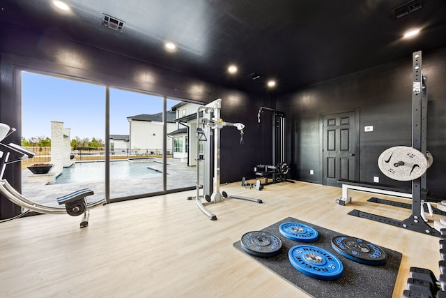 gym with wood finished floors and visible vents