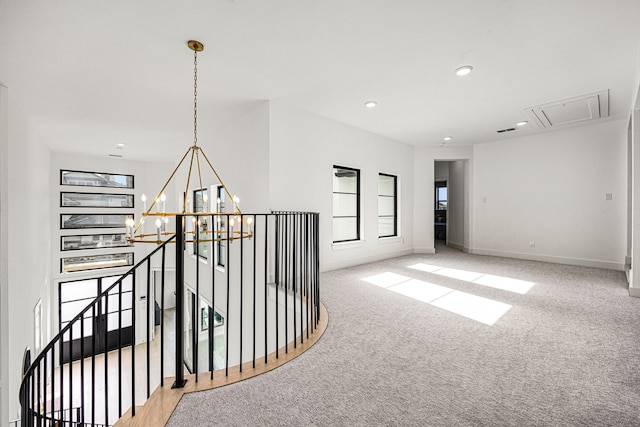 hallway featuring a chandelier, recessed lighting, carpet floors, an upstairs landing, and attic access