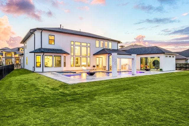 back of house at dusk with a fenced backyard, an outdoor pool, a lawn, and a patio