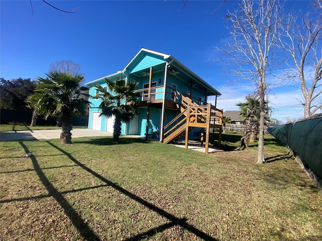 back of property featuring a yard and a garage