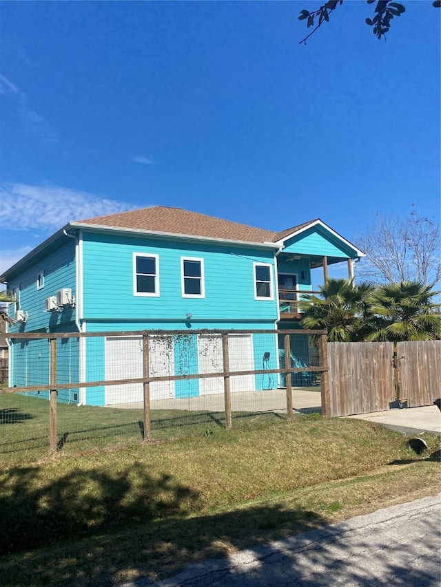 rear view of property with a balcony and a lawn