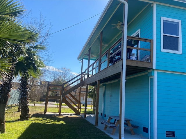 view of home's exterior featuring a lawn, ceiling fan, and a patio area