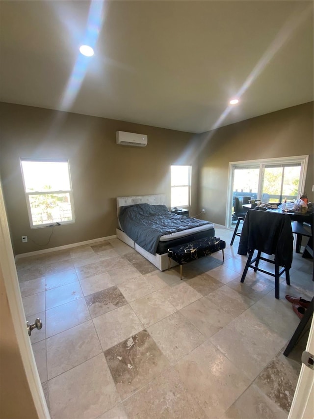 bedroom featuring multiple windows and a wall unit AC