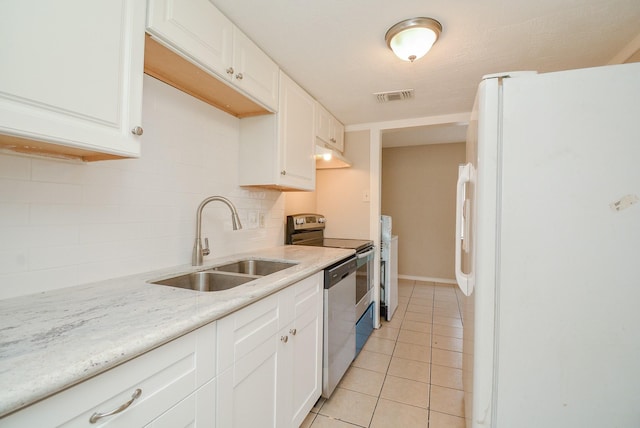 kitchen featuring stainless steel appliances, sink, light tile patterned floors, and white cabinets