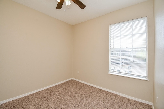 carpeted spare room featuring ceiling fan