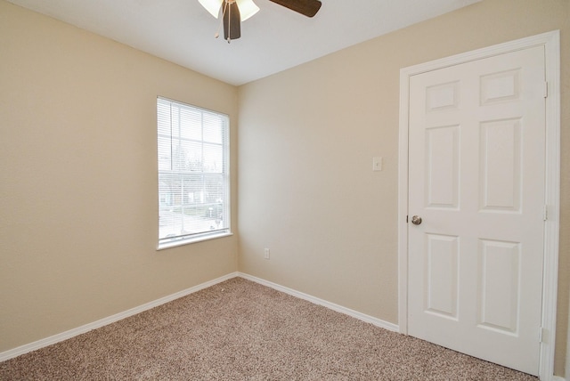 carpeted empty room featuring ceiling fan